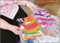  ?? Christian Abraham/Hearst Connecticu­t Media ?? Linda Bracken displays some of the 175 hats she knitted over the past nine months.