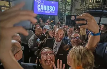  ?? Apu Gomes/Getty Images ?? Los Angeles Democratic mayoral candidate Rick Caruso with supporters Tuesday during a primary election event in Los Angeles. Rep. Karen Bass, D-Calif., and Mr. Caruso are expected to face each other in a runoff mayoral election in November.