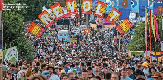  ?? Guy Bell ?? Crowds pass under the ‘Revolt’ arch in the green fields on Thursday