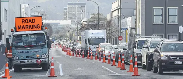  ?? PHOTO: GERARD O’BRIEN ?? Slow journey . . . Vehicles backed up in Castle St, Dunedin, as cycleway constructi­on continues.