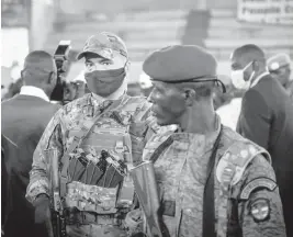  ?? BARBARA DEBOUT/AFP ?? A private security guard from Russia’s Wagner Group, left, stands next to a Central African Republic soldier during a rally March 18 in the capital city of Bangui.