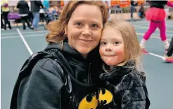  ??  ?? Bobi Miller and her daughter Sydney return to the cosy Butterdome in Batman costumes after completing the run/walk.