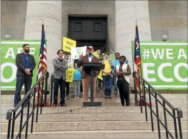  ?? ASSOCIATED PRESS FILE ?? Bill Lager, center in cap, founder of Ohio’s largest online charter school, the Electronic Classroom of Tomorrow or ECOT, speaks to hundreds of supporters during a May 2017 rally outside the Statehouse in Columbus.