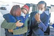  ?? AP PHOTO/SETH WENIG ?? Danny Fenster, center, hugs his mother Rose Fenster as former U.S. diplomat Bill Richardson, right, looks on Tuesday at John F. Kennedy Airport in New York.