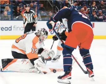  ?? PAUL VERNON/AP ?? Flyers goalie Carter Hart stops a shot in front of Columbus Blue Jackets forward Emil Bemstrom during Thursday’s game.