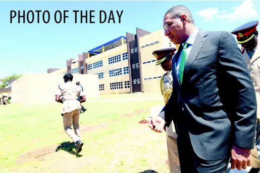  ??  ?? Prime Minister Andrew Holness (right) and Lt Gen Rocky Meade, chief of defence staff, Jamaica Defence Force, in discussion as they walk away after unveiling a plaque to officially open the Lathbury Barracks office and accommodat­ion (in background) at Up Park Camp yesterday.