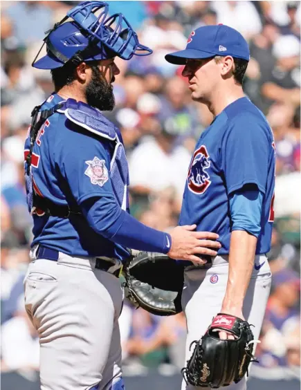  ?? NAM Y. HUH/AP ?? Cubs catcher Austin Romine talks with starter Kyle Hendricks, who was roughed up for eight runs in 4‰ innings Sunday.