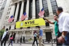  ?? —AP photos ?? NEW YORK: A Snapchat banner hangs on the facade of the New York Stock Exchange.