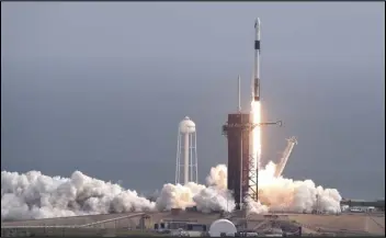  ?? ASSOCIATED PRESS ?? A Falcon 9 SpaceX rocket lifts off Sunday from pad 39A during a test flight to demonstrat­e the capsule’s emergency escape system at the Kennedy Space Center in Cape Canaveral, Fla.