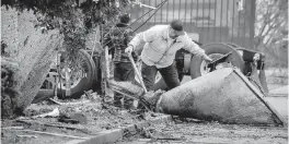  ?? ALLEN J. SCHABEN Los Angeles Times ?? Cleanup crews remove a large piece of debris after a tornado with wind gusts up to 110 mph touched down in Montebello, California, for several minutes earlier this week.