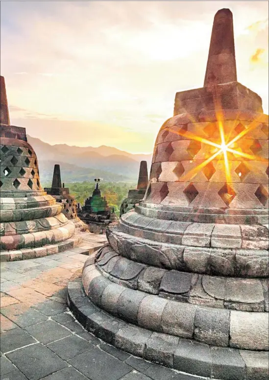  ?? Nur Yunianto Getty Images/EyeEm ?? TRY WATCHING THE SUN RISE at the Buddhist temple of Borobudur on the island of Java in Indonesia. There are 50 countries’ worth of adventures in Asia.