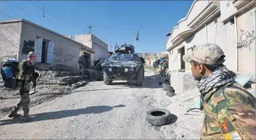  ?? Ahmad al-Rubaye AFP/Getty Images ?? IRAQI SECURITY FORCES are deployed in Albu Sayf, south of the city of Mosul, on the third day of an offensive to retake the western side of the city from Islamic State. Albu Sayf had been an Islamic State base.