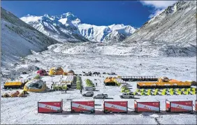  ?? AP ?? Vehicles and tents are seen at the base camp on the Chinese side of Mount Everest in Tibet