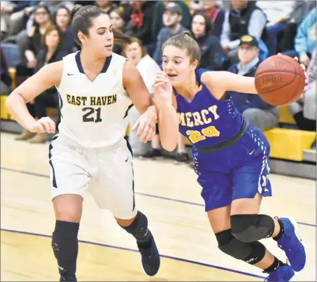  ?? Peter Hvizdak / Hearst Connecticu­t Media ?? East Haven’s Isabella Ragaini, left, defends as Mercy’s Kameryn King drives during Monday’s game.