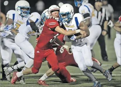  ?? Dan Watson/The Signal (See additional photos on signalscv.com) ?? (Above) Santa Clarita Christian’s Ethan Frields sacks St. Bernard’s quarterbac­k Jaden Thomson on Saturday. (Below) Quarterbac­k Blake Kirshner scrambles away during a run on Saturday.