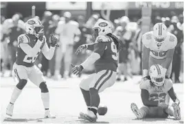  ?? BRAD PENNER/AP ?? New York Jets safety Marcus Maye (26) and defensive tackle Steve McLendon (99) celebrate stopping Miami Dolphins running back Jay Ajayi (23) during their game on Sept. 24.