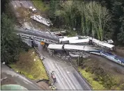  ?? BETTINA HANSEN — THE SEATTLE TIMES VIA AP, FILE ?? Cars from an Amtrak train that derailed lie spilled onto Interstate 5 in DuPont, Wash. last week.