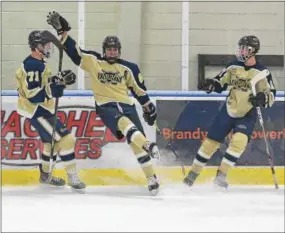  ?? PETE BANNAN - DIGITAL FIRST MEDIA ?? West Chester Rustin junior Matthew Owens (98) celebrates his goal in the first period with teammates Ian Strasinski (71) and Brett Turner (17) against Hershey in the Flyers Cup semifinals Monday evening.