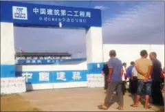  ?? SUPPLIED ?? Chinese workers outside a constructi­on site at Phnom Penh’s Boeung Kak developmen­t area yesterday.