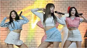  ?? — aFP ?? Cut-throat battle: K-pop group Brave Girls performing during a commercial event in Gwacheon, seoul. The K-pop industry is accused of consuming young hopefuls, with only a tiny minority surviving to stardom.