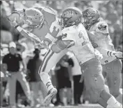  ??  ?? TREVON SIDNEY makes a 41-yard catch against Rebels to keep a fourth-quarter scoring drive alive.