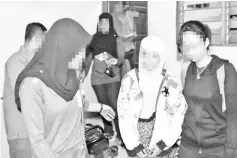  ??  ?? Counter Terrorism officers detaining the 24-year-old Malaysian woman who transferre­d RM4,000 to a militant who was killed in Syria earlier this year.