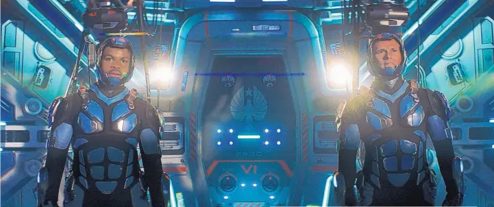  ?? COURTESY OF LEGENDARY PICTURES/UNIVERSAL PICTURES ?? John Boyega, left, and Scott Eastwood in a scene from “Pacific Rim Uprising.”