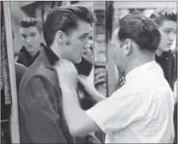  ?? BERNARD LANSKY/ THE ASSOCIATED PRESS FILES ?? Elvis Presley is outfitted by clothier Bernard Lansky at Lansky’s Men’s Store in Memphis, Tenn in 1956. Lansky died Thursday at his Memphis home.