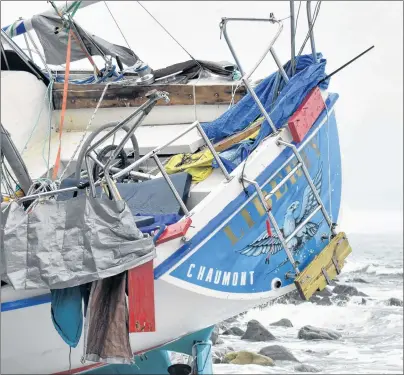  ?? CAPE BRETON POST ?? The stern of the Liberty, an 11-metre sailboat stranded on the shores of Gabarus. The whereabout­s of the vessel’s skipper, who was spotted by several residents leaving the village on foot with his dog, is still not known.