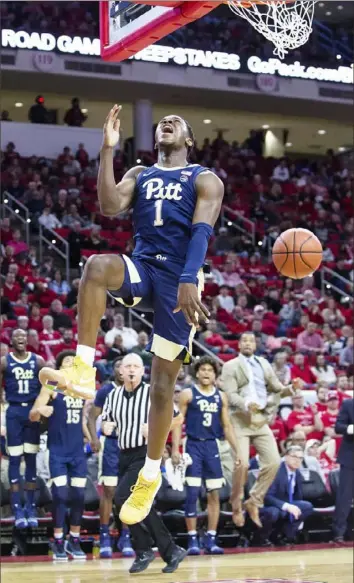  ?? Associated Press ?? Pitt’s Xavier Johnson finishes a dunk Saturday in the Panthers’ 86-80 loss to N.C. State in Raleigh, N.C. Johnson led the Panthers with 25 points.