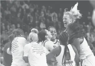  ?? ?? North Carolina State’s Raina Perez and Elissa Cunane celebrate with teammates after their 66-63 win over Notre Dame in an NCAA Bridgeport Regional semifinal game on Saturday at Total Mortgage Arena, Bridgeport. CLOE POISSON/SPECIAL TO THE COURANT