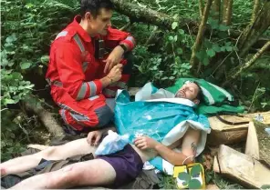  ??  ?? Forest rescue: A paramedic prepares to take Mr Robbins to hospital