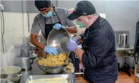  ??  ?? Syrian refugee Mohammad Jaber, right, and helper Mahmoud Mohammed Salad preparing food at Jaber’s catering kitchen. Photograph: Hasnoor Hussain/The Guardian