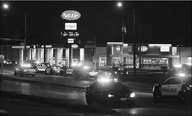  ??  ?? Police cars surround a Kum & Go gas station on East Chestnut Expressway in Springfiel­d, Missouri. Photograph: Nathan Papes. (Photo: The Guardian)