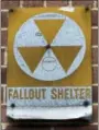  ?? MARY ALTAFFER - THE ASSOCIATED PRESS ?? In this Tuesday, Jan. 16, 2018 photo, a fallout shelter sign hangs on a building on East 9th Street in New York. The fallout shelters, marked with metal signs featuring the symbol for radiation — three joined triangles inside a circle — were set up in...