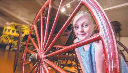  ??  ?? OUR PAST: Isla Rossow, 9, from Gowrie Junction explores Cobb and Co’s national carriage collection.