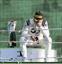  ?? JENNIFER LORENZINI / ASSOCIATED PRESS ?? After a raucous celebratio­n with his team, AlfaTauri driver Pierre Gasly savors a moment alone on the podium in winning the Italian Grand Prix in Monza, his first career Formula One victory.
