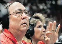  ?? JARED LAZARUS Miami Herald | April 19, 2005 ?? Jim Cox ‘calls’ the game as Sherry Furnari inputs the stats from his calls into a computer during a Miami Heat game. Cox was a leading statistici­an at Miami Heat, Miami Dolphins and Miami Hurricanes games.