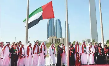  ?? Abdul Rahman/Gulf News ?? Dr Amal Al Qubaisi, Speaker of the Federal National Council (FNC), raises the UAE flag in the presence of FNC members at the FNC headquarte­rs in Abu Dhabi yesterday.