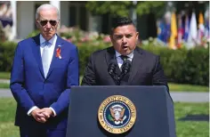  ?? The Associated Press ?? ■ President Joe Biden listens as Uvalde, Texas, pediatrici­an Roy Guerrero speaks during an event to celebrate the passage of the “Bipartisan Safer Communitie­s Act,” a law meant to reduce gun violence, on the South Lawn of the White House on Monday in Washington.