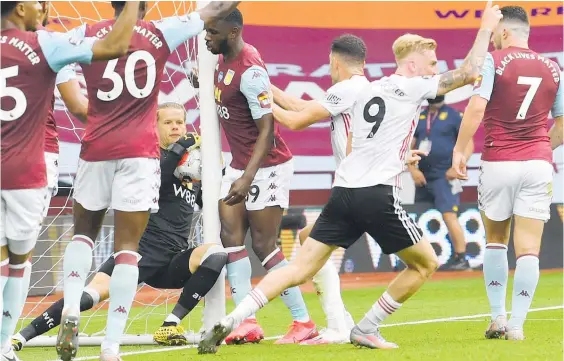  ?? Photo / AP ?? Aston Villa goalkeeper Ørjan Nyland carries the ball over his own goalline after catching an inswinging Sheffield United free kick.