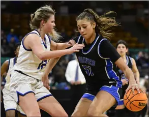  ?? ANDY CROSS — THE DENVER POST ?? Grandview’s Sienna Betts, right, dribbles while guarded by Highlands Ranch’s Maddie Groth in the first half of their Class 6A girls quarterfin­al on Saturday at the Denver Coliseum.