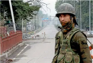  ?? AP ?? An Indian paramilita­ry soldier stands guard on a road leading towards Independen­ce Day parade venue in Srinagar.