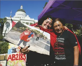  ?? RICH PEDRONCELL­I/ASSOCIATED PRESS ?? FARMWORKER­S CYNTHIA BURGOS (LEFT) and Teresa Maldonado hug after Gov. Gavin Newsom signed a bill aimed at making it easier for farmworker­s to unionize in Sacramento, Calif., on Sept. 28, 2022. One of California’s most in uential agricultur­al companies announced Monday that it is suing the state to stop the contentiou­s law to help farmworker­s unionize. The legal action by the Wonderful Co. comes as it battles United Farm Workers over a newly formed union at one of its businesses.