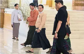  ??  ?? Moving on: Win Myint (centre) leaving parliament in the capital Naypyidaw.