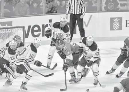  ?? MICHAEL LAUGHLIN/SOUTH FLORIDA SUN SENTINEL ?? The Panthers’ Aleksander Barkov tries to control the puck against the Oilers’ Connor McDavid on Saturday.