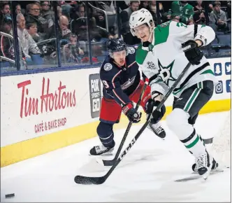  ?? [BROOKE LAVALLEY/DISPATCH] ?? The Blue Jackets’ Artemi Panarin, left, and Dallas’ John Klingberg vie for the puck behind the Stars goal in the first period on Thursday night.