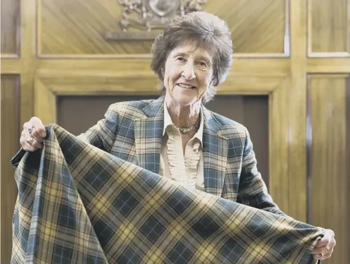  ??  ?? Senior director Deirdre Kinloch Anderson pictured with the special sundial tartan created in honour of the project and anniversar­y
