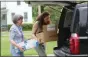  ??  ?? Madison County Historical Society Executive Director Sydney Loftus, right, and Eileen Kinsella move boxes of documents out of the Hazel Carpenter Adult Home to go to the Madison County Historical Society on Wednesday, Aug. 7.