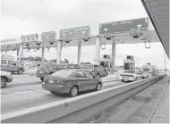  ?? Houston Chronicle ?? Toll booth operators staff the many lanes of a portion of the Sam Houston Tollway collecting motorists’ fees. Tolls helped pay for the highway.